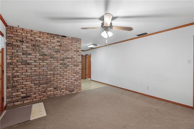 unfurnished room with ornamental molding, light colored carpet, and brick wall