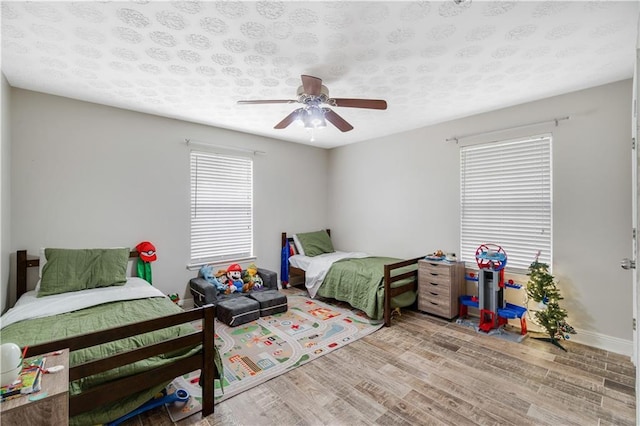 bedroom featuring light hardwood / wood-style flooring and ceiling fan