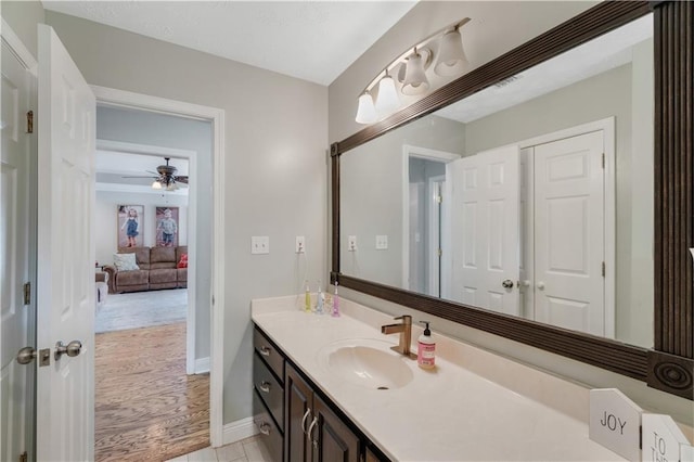 bathroom with vanity, hardwood / wood-style flooring, and ceiling fan