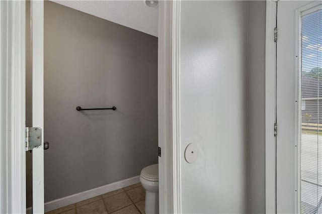 bathroom featuring tile patterned floors and toilet