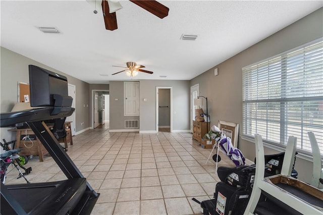 exercise room with light tile patterned floors