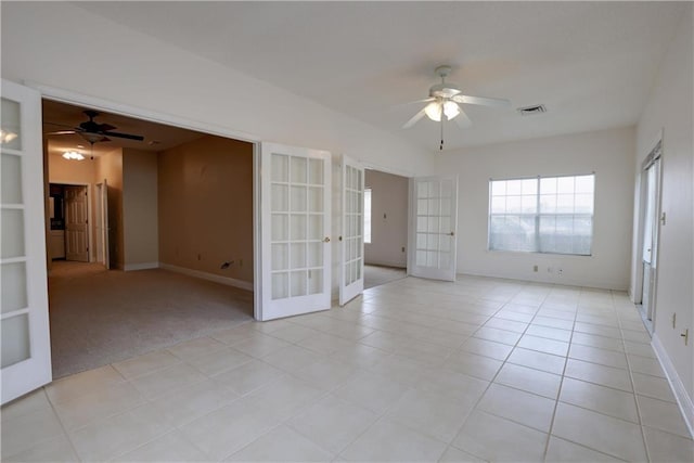 empty room featuring light carpet, french doors, and ceiling fan