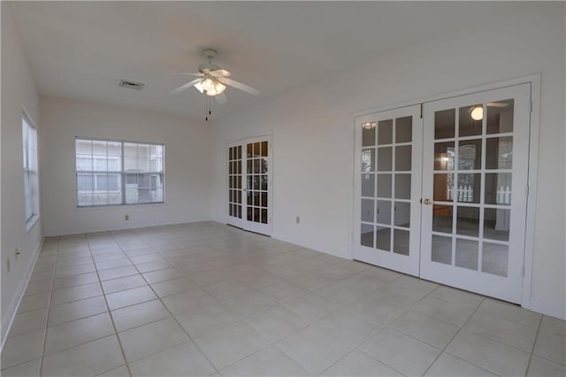 unfurnished room featuring french doors, ceiling fan, and light tile patterned floors