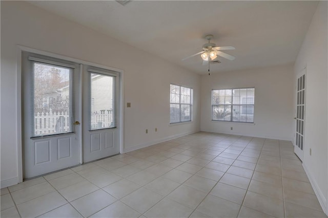 tiled entrance foyer with ceiling fan and french doors