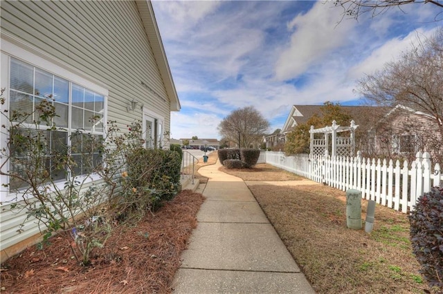 view of property exterior with a pergola