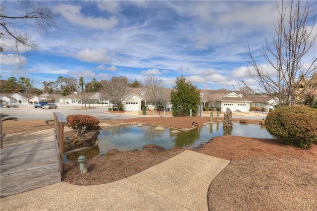 view of pool featuring a water view