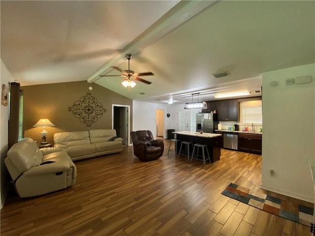 living area featuring lofted ceiling with beams, visible vents, ceiling fan, and dark wood-style floors