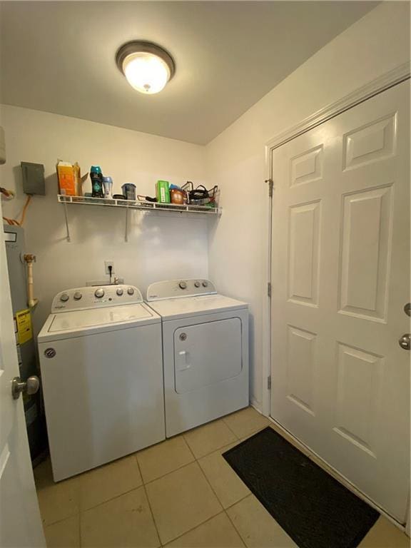 washroom with laundry area, independent washer and dryer, and light tile patterned floors