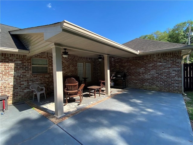 view of patio with area for grilling and a ceiling fan