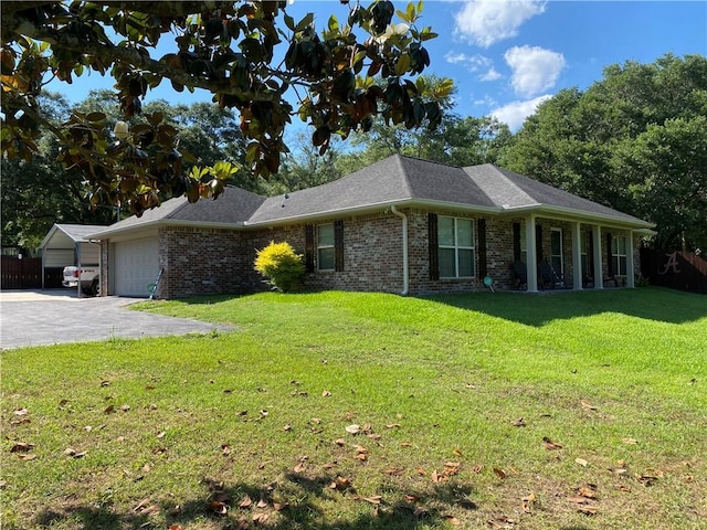 view of front of property with a front yard, brick siding, a garage, and aphalt driveway
