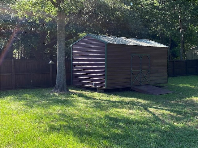 view of shed with a fenced backyard