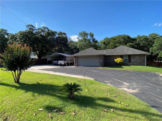 ranch-style house featuring a garage, aphalt driveway, a front lawn, a detached carport, and brick siding