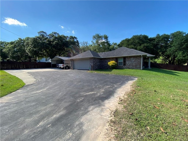 ranch-style home featuring a front yard, driveway, an attached garage, and fence
