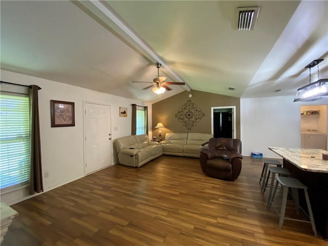 living room with dark wood finished floors, visible vents, a ceiling fan, and vaulted ceiling with beams