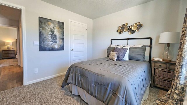 bedroom featuring carpet floors and baseboards