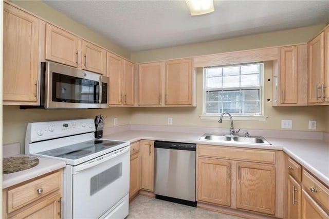 8522 Brandy Oak Ct, Mobile, AL 36695 - kitchen featuring appliances with stainless steel finishes, a sink, light brown cabinets, and light countertops