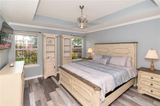 8522 Brandy Oak Ct, Mobile, AL 36695 - bedroom featuring a tray ceiling, wood finished floors, baseboards, ornamental molding, and ceiling fan