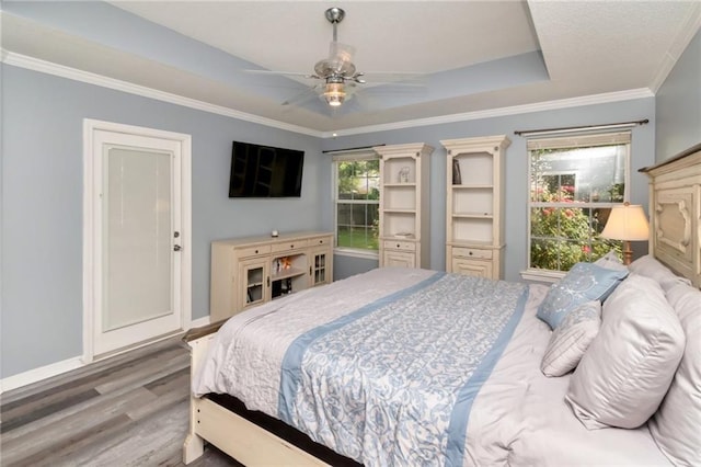8522 Brandy Oak Ct, Mobile, AL 36695 - bedroom with wood finished floors, ornamental molding, baseboards, ceiling fan, and a raised ceiling