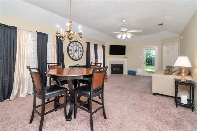 8522 Brandy Oak Ct, Mobile, AL 36695 - dining area featuring light colored carpet, lofted ceiling, a fireplace, a chandelier, and a ceiling fan