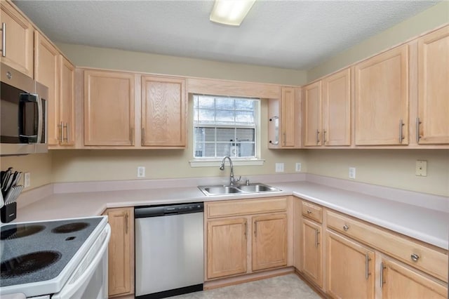 8522 Brandy Oak Ct, Mobile, AL 36695 - kitchen with appliances with stainless steel finishes, a sink, light brown cabinets, light countertops, and a textured ceiling