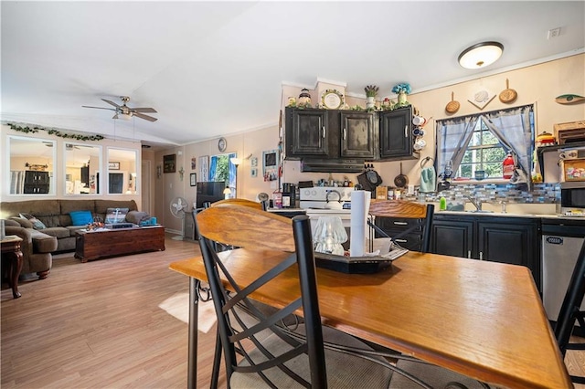 kitchen featuring lofted ceiling, ornamental molding, light hardwood / wood-style floors, and ceiling fan