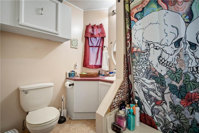 bathroom featuring vanity, toilet, and a textured ceiling