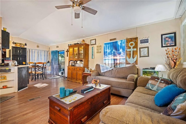 living room with lofted ceiling, wood-type flooring, and ceiling fan