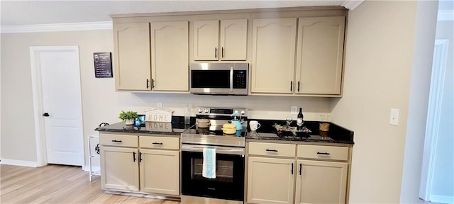 7041 Tierra W, Eight Mile, AL 36613 - kitchen featuring stainless steel appliances, ornamental molding, light wood-style floors, and dark stone counters