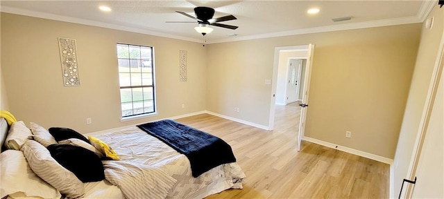 bedroom featuring ornamental molding, light hardwood / wood-style floors, and ceiling fan