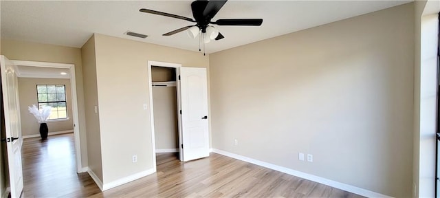 unfurnished bedroom with light hardwood / wood-style floors, a closet, and ceiling fan