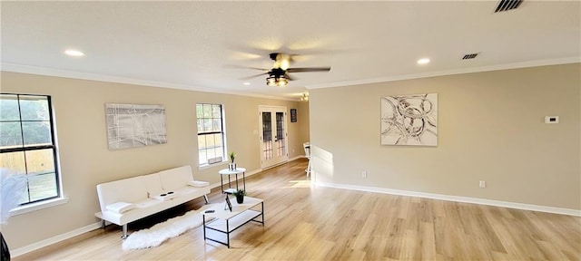 unfurnished room with ornamental molding, light wood-type flooring, and ceiling fan