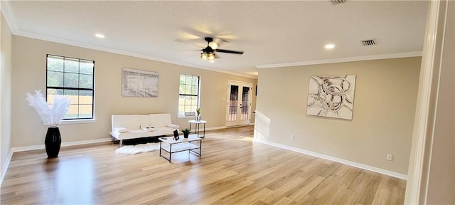 living area featuring light hardwood / wood-style floors, crown molding, and ceiling fan