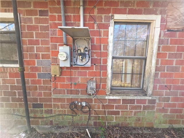 exterior details with brick siding and electric meter