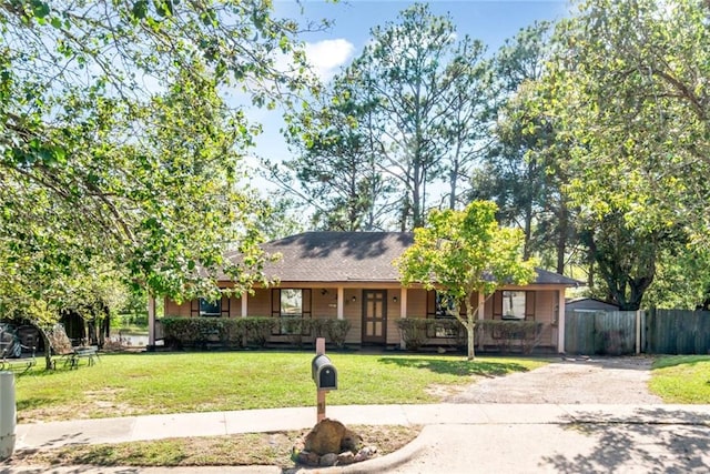 ranch-style home featuring a front yard