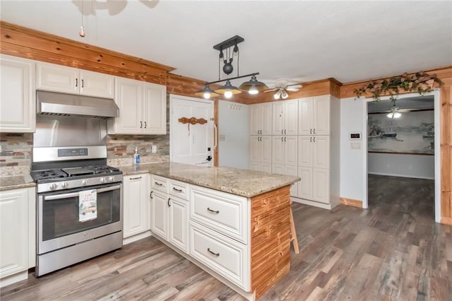 kitchen featuring white cabinets, wood-type flooring, stainless steel range with gas cooktop, and ceiling fan