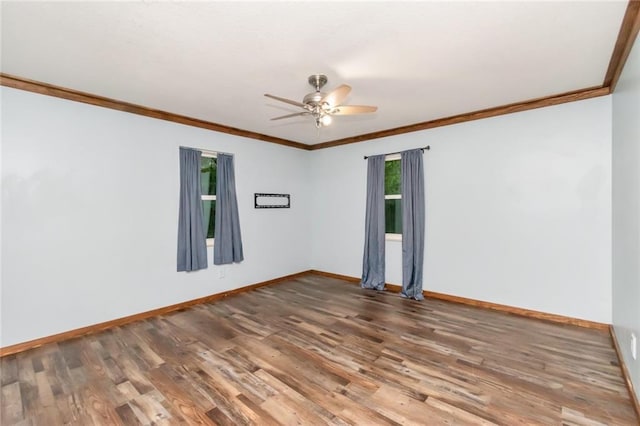 empty room featuring ceiling fan, hardwood / wood-style flooring, and crown molding