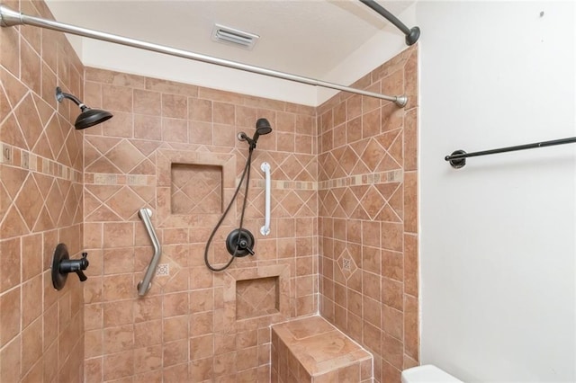 bathroom featuring a tile shower