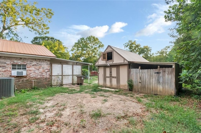 view of yard with central air condition unit and a shed