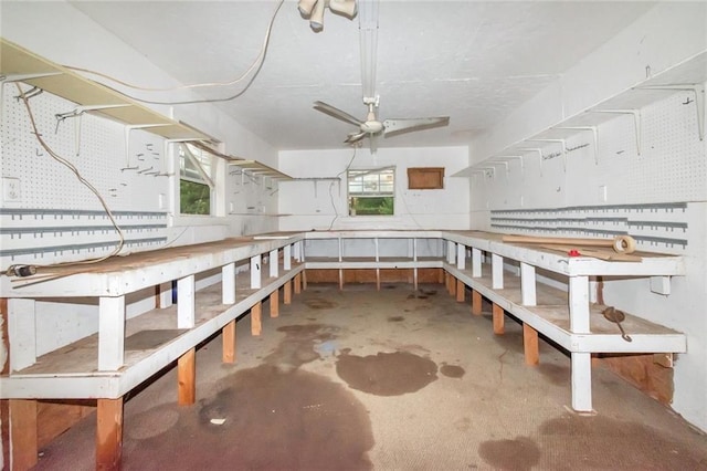 interior space with ceiling fan and concrete floors