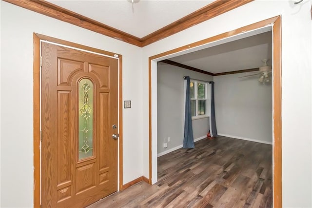 foyer with dark wood-type flooring, ceiling fan, and ornamental molding