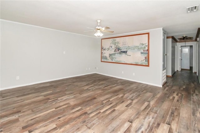 empty room featuring dark wood-type flooring, ceiling fan, and crown molding