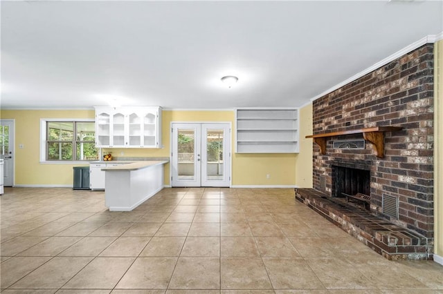 kitchen featuring white cabinetry, a healthy amount of sunlight, light tile patterned flooring, and kitchen peninsula