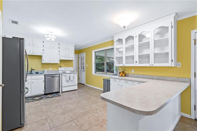 kitchen with white cabinetry, light tile patterned floors, ornamental molding, appliances with stainless steel finishes, and kitchen peninsula