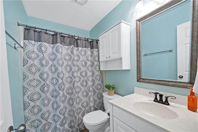 bathroom with vanity, curtained shower, and toilet