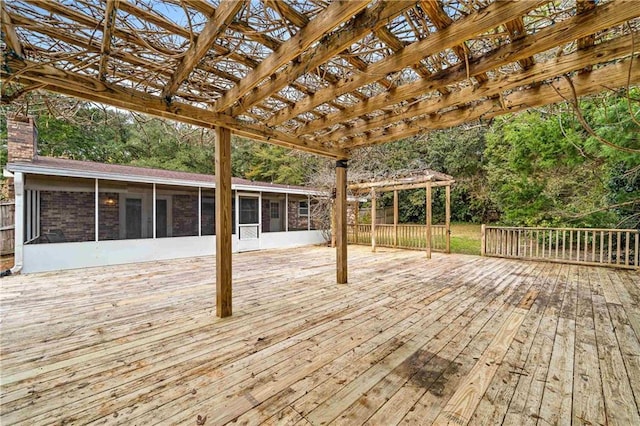 deck with a sunroom and a pergola