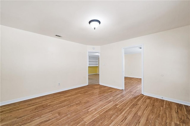 unfurnished room with hardwood / wood-style floors