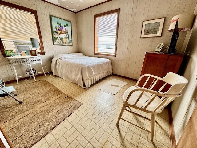 bedroom featuring brick floor, baseboards, wooden walls, and ornamental molding