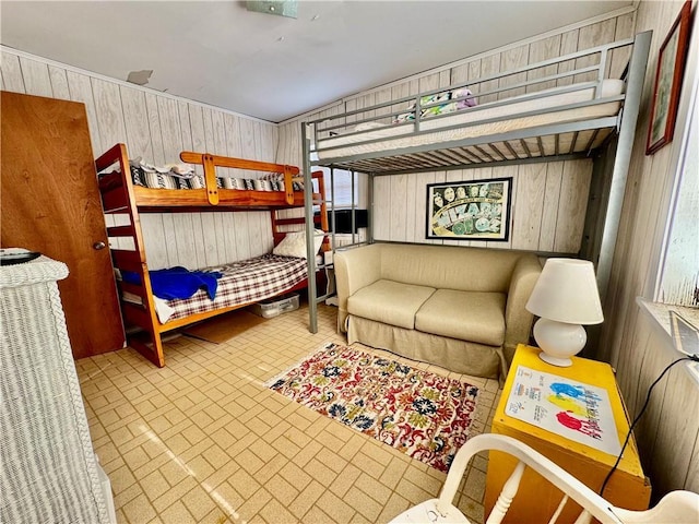 bedroom with wooden walls and brick patterned floor