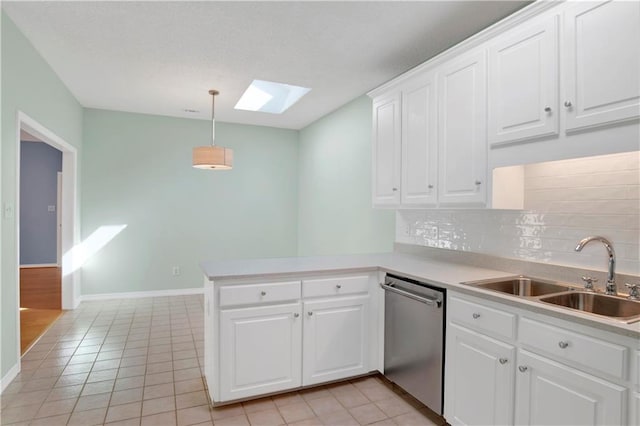 kitchen with white cabinetry, kitchen peninsula, dishwasher, and sink