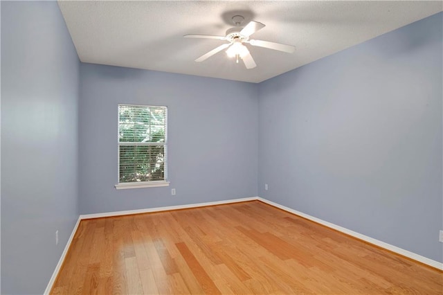 empty room featuring ceiling fan and hardwood / wood-style floors